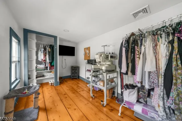 a view of walk in closet with clothes and shoes