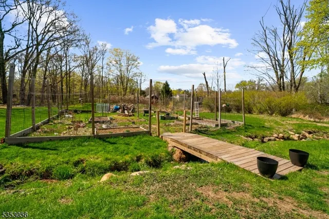 a view of yard with swimming pool and green space