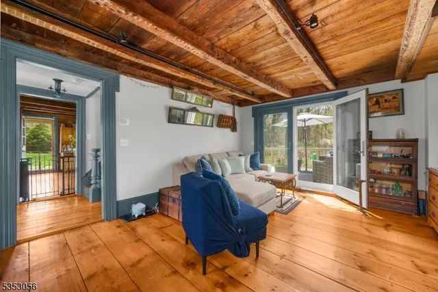 a living room with furniture a flat screen tv and floor to ceiling windows