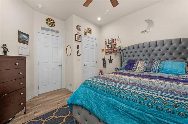 a bedroom with a bed and wooden floor