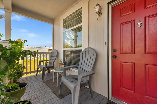 a view of a balcony dining area with furniture window and wooden floor