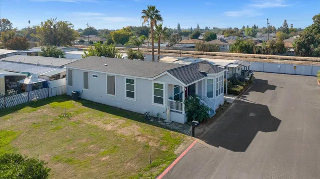 an aerial view of a house with a yard basket ball court and outdoor seating