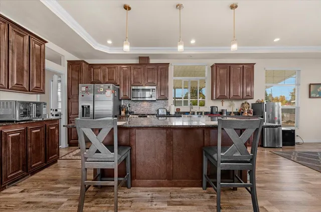a kitchen with a table chairs refrigerator and cabinets