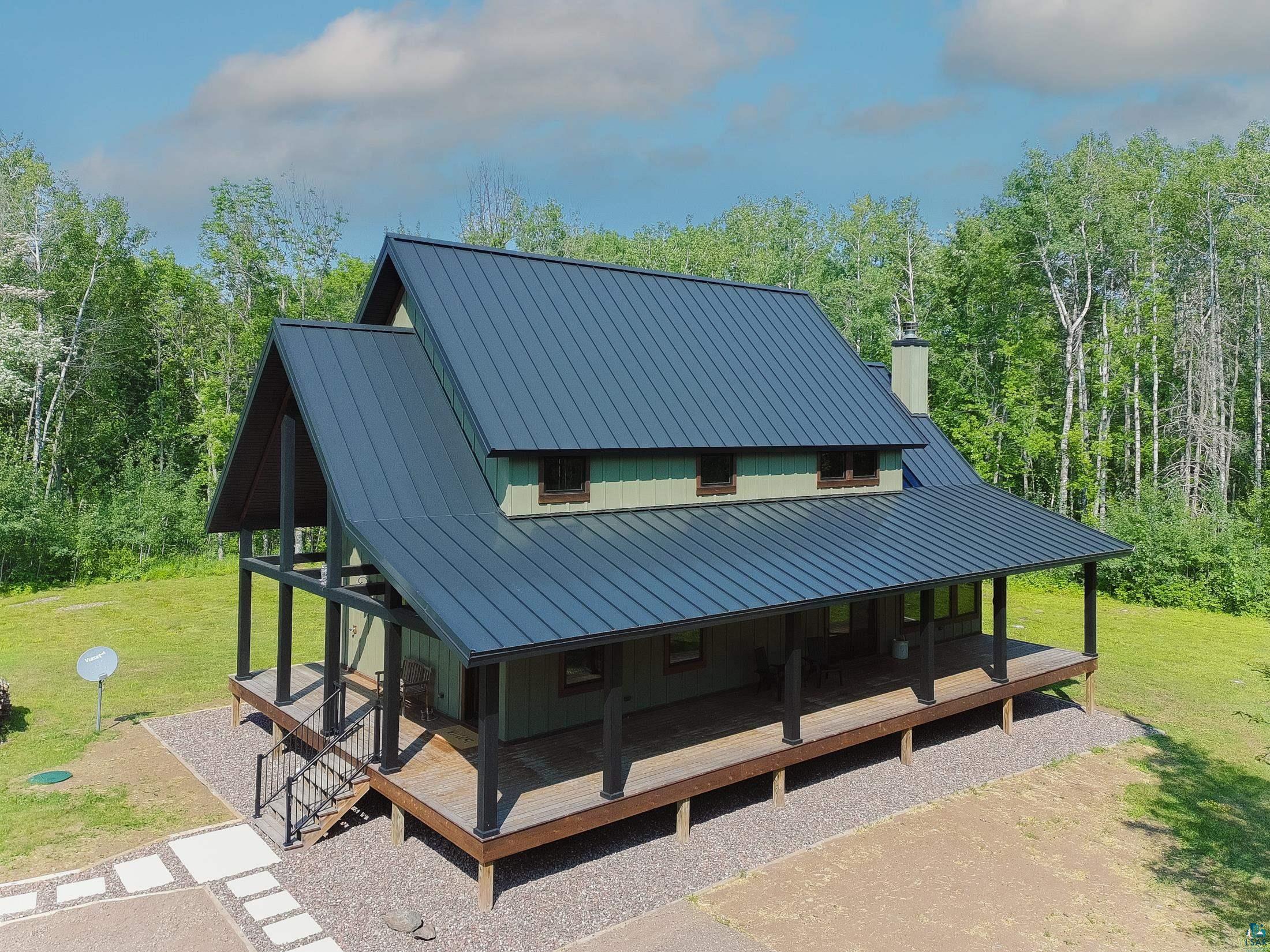 3778 East County Road Barnum, MN 55707 - Photo 1 of 52 Gable roofline with a dark metal finish, expansive wrap-around porch, and an exterior chimney