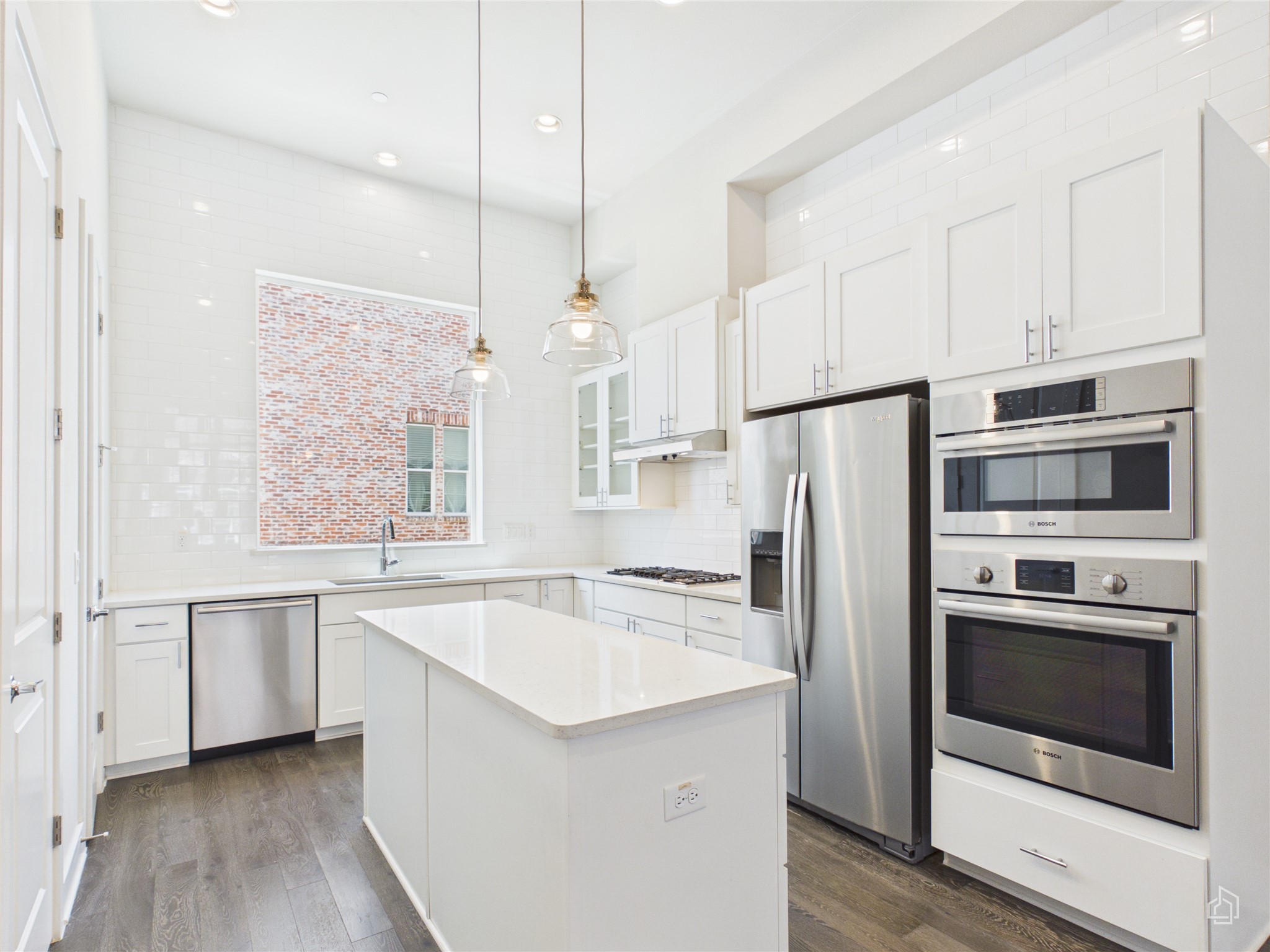 1308 Tinnin Ford Road, Unit 14 Austin, TX 78741 - Photo 1 of 40 High ceilings and sleek stone countertops define this modern kitchen with premium integrated appliances.