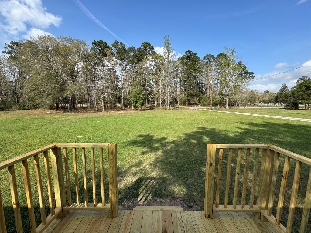 23278 Morgan Cemetery Road Splendora, TX 77372 - Photo 19 of 27 a view of a deck with a yard and trees