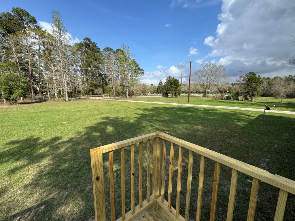23278 Morgan Cemetery Road Splendora, TX 77372 - Photo 20 of 27 a view of a wooden deck and a yard