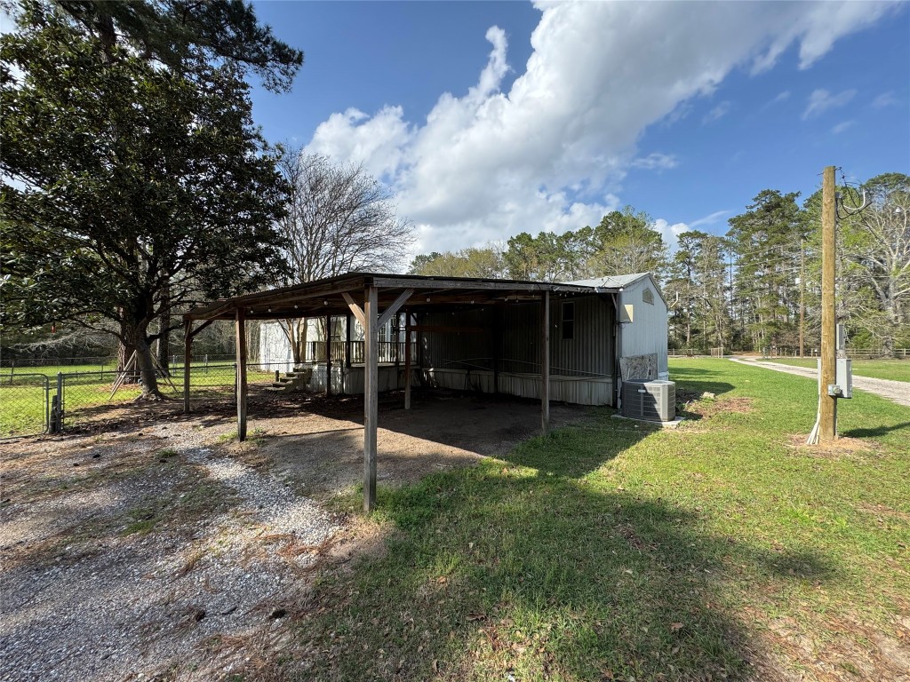23278 Morgan Cemetery Road Splendora, TX 77372 - Photo 22 of 27 a view of a house with backyard and a tree
