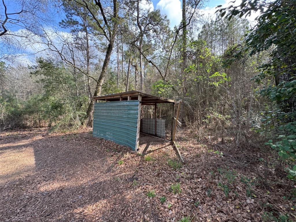 23278 Morgan Cemetery Road Splendora, TX 77372 - Photo 26 of 27 a backyard of a house with table and chairs