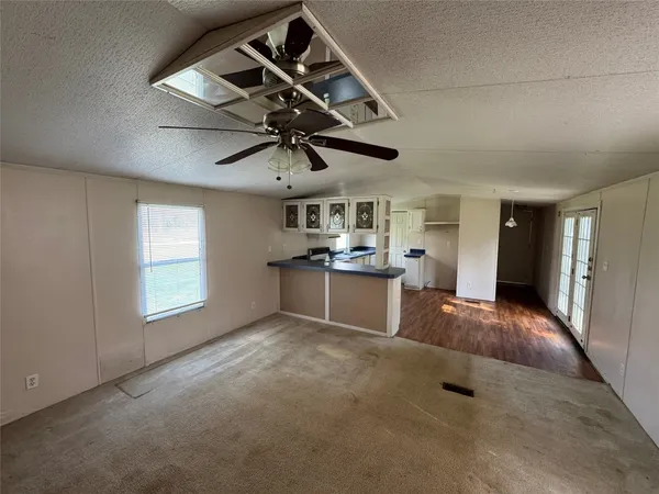 a view of field with trees in the background