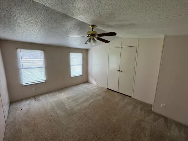 a view of a house with backyard and a tree