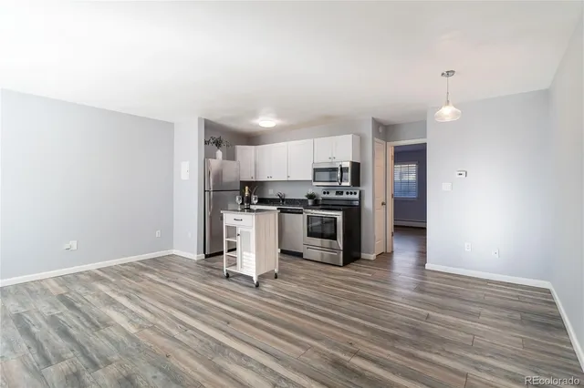 a kitchen with stainless steel appliances a refrigerator and a stove top oven