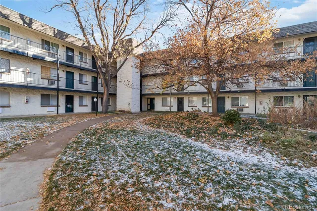 a front view of a residential apartment building with a yard