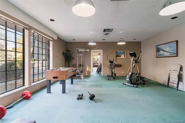 a room with gym equipment and a large window