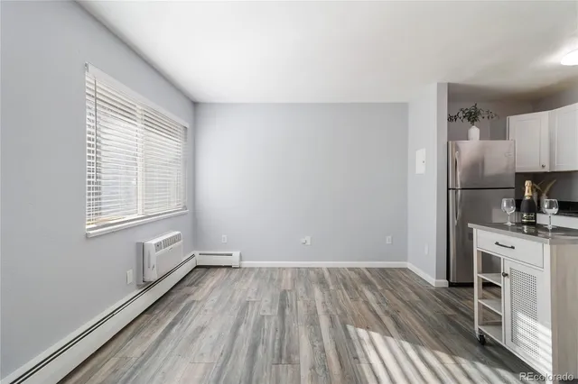 a view of kitchen with wooden floor electronic appliances and window