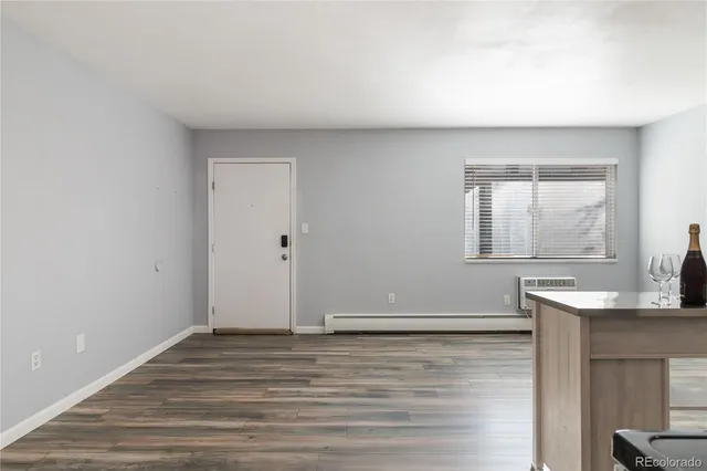 a view of a livingroom with wooden floor and a window