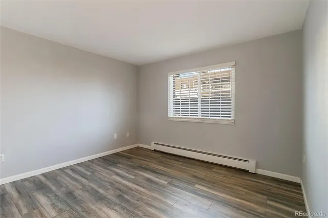 wooden floor in an empty room with a window
