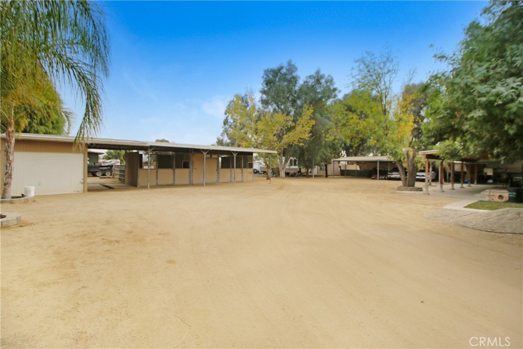 30620 Old Windmill Road Menifee, CA 92584 - Photo 11 of 14 a view of swimming pool with outdoor seating and covered with trees in the background