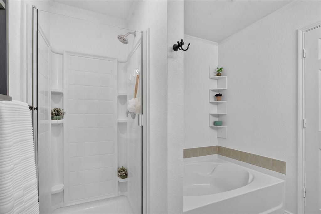 12933 Azure Heights Place Rhome, TX 76078 - Photo 25 of 37 Shower enclosure with glass paneling, a built-in shower caddy, and a fixed shower head