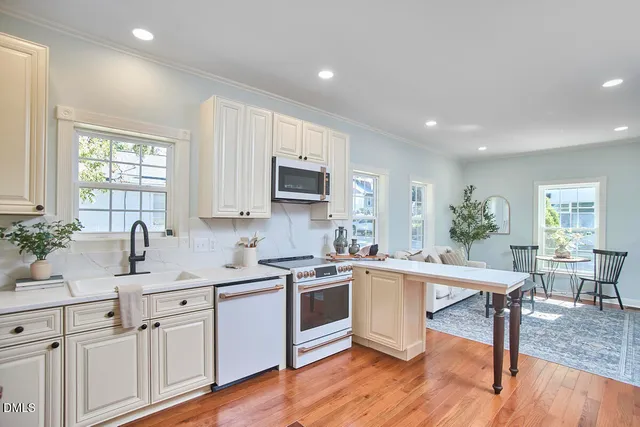 a bathroom with a granite countertop sink toilet and bathtub