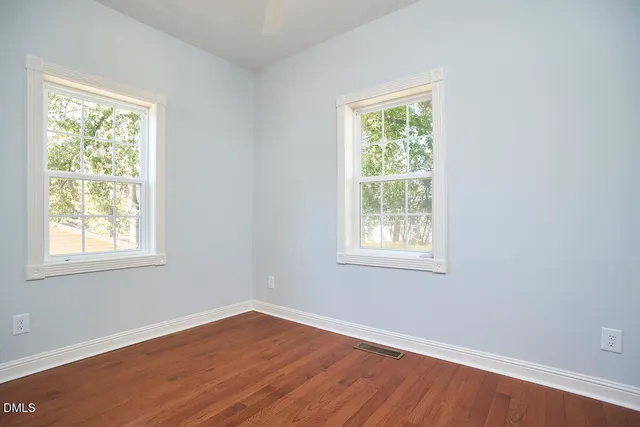 a view of a dining room with furniture and a window