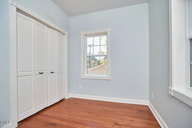 a view of a small room with a door and a potted plant