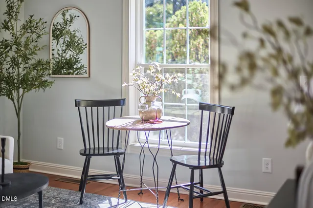 a dining room with furniture and wooden floor