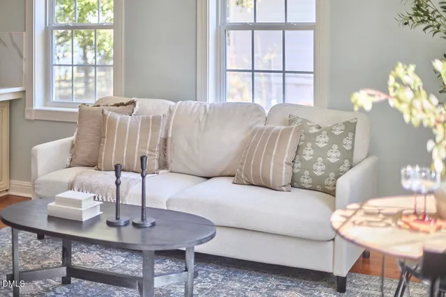 a kitchen with stainless steel appliances granite countertop a sink a stove and a refrigerator with white cabinets