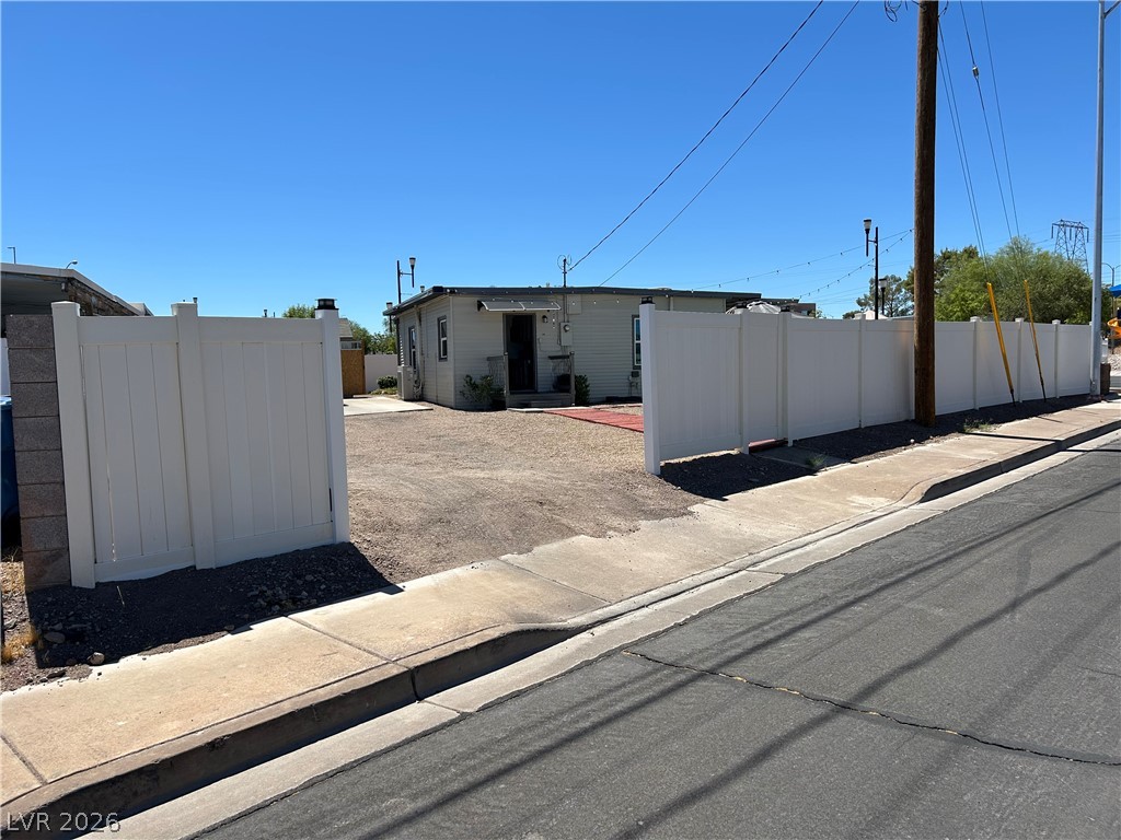 116 West Basic Road Henderson, NV 89015 - Photo 37 of 39 Secure property offering a wide fenced yard and inviting entry.