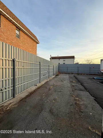 a view of a pathway with a wooden fence
