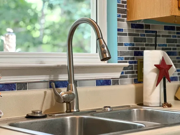 a kitchen with stainless steel appliances a stove a sink and a refrigerator