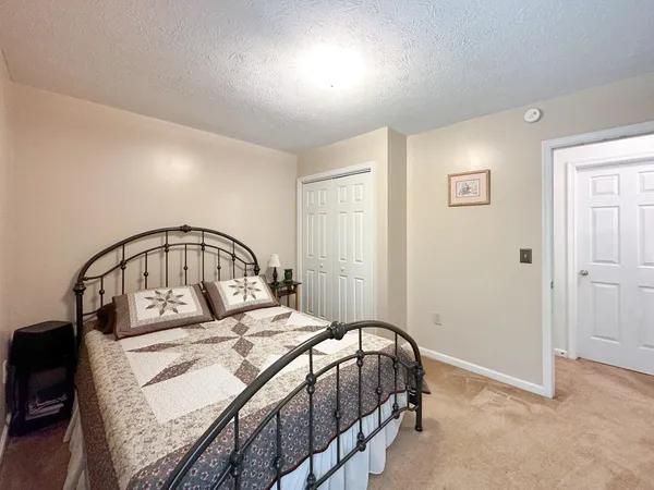 a bedroom with a large bed and a mirror