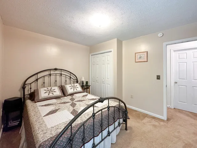 a bedroom with a large bed and a mirror