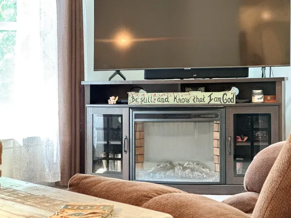 a living room with furniture and a flat screen tv