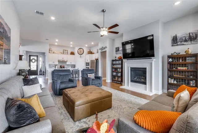a living room with furniture fireplace and flat screen tv