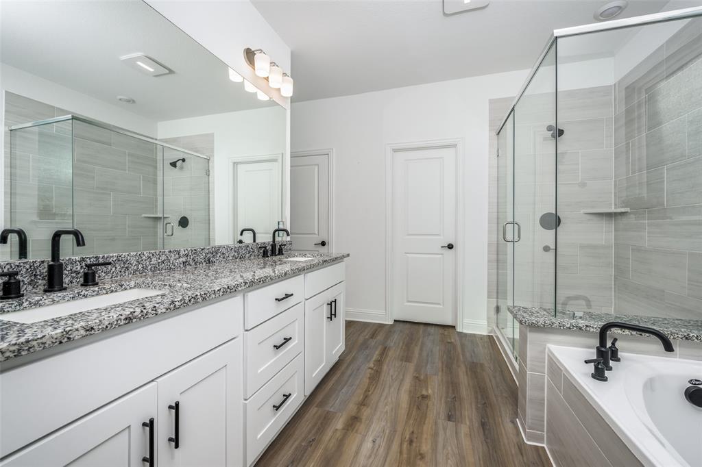 337 Augusta Court Oak Point, TX 75068 - Photo 14 of 26 a bathroom with a granite countertop double vanity sink a mirror and shower