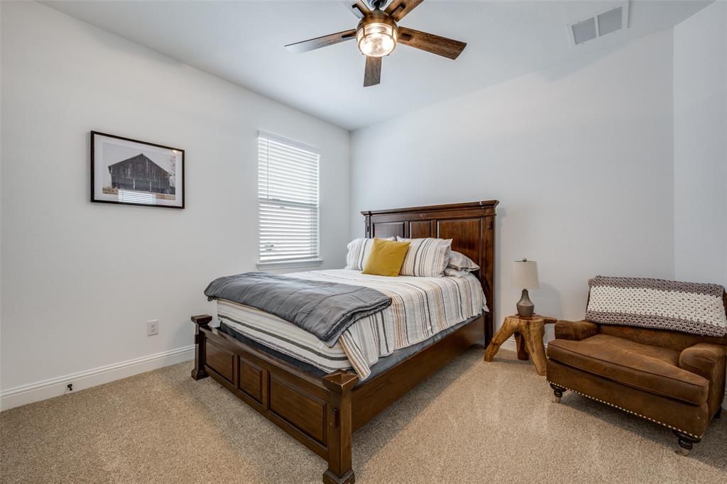 337 Augusta Court Oak Point, TX 75068 - Photo 16 of 26 a bedroom with a bed and a couch