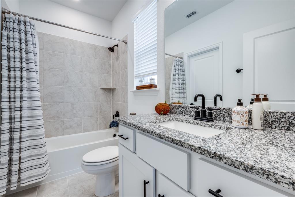 337 Augusta Court Oak Point, TX 75068 - Photo 5 of 26 a bathroom with a granite countertop sink mirror toilet and bathtub