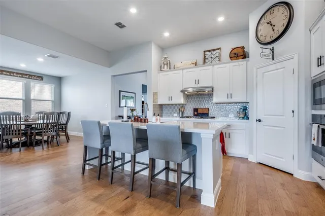 a view of kitchen with cabinets and wooden floor