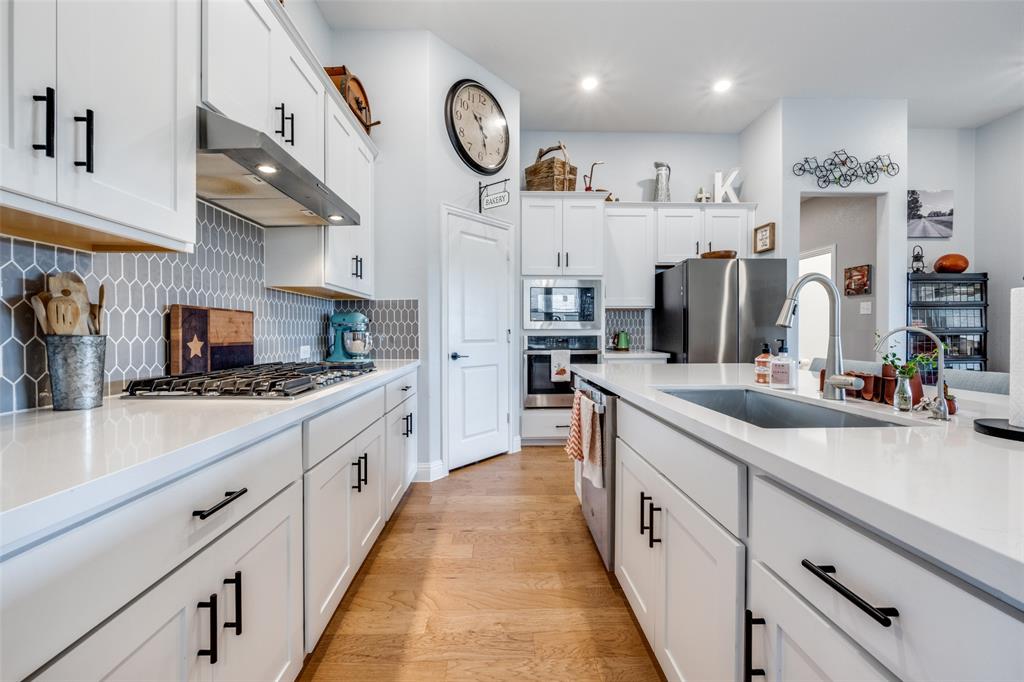 337 Augusta Court Oak Point, TX 75068 - Photo 8 of 26 a large kitchen with stainless steel appliances lots of counter space and a sink