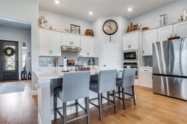 a view of kitchen with cabinets and stainless steel appliances