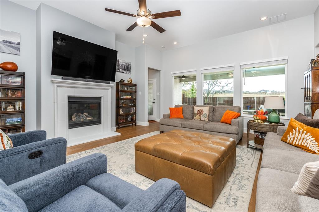 337 Augusta Court Oak Point, TX 75068 - Photo 10 of 26 a living room with fireplace furniture and a flat screen tv