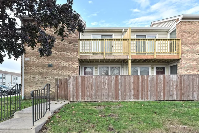 a view of a house with wooden floor and a fence