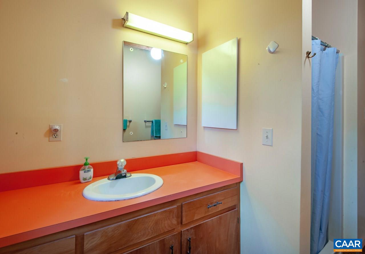 140 Rainbow Ridge Road Faber, VA 22938 - Photo 26 of 32 a bathroom with a sink and a mirror