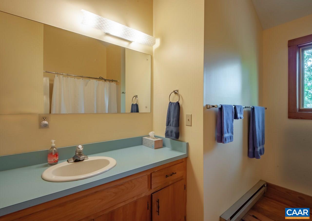 140 Rainbow Ridge Road Faber, VA 22938 - Photo 27 of 32 a bathroom with a sink and a mirror