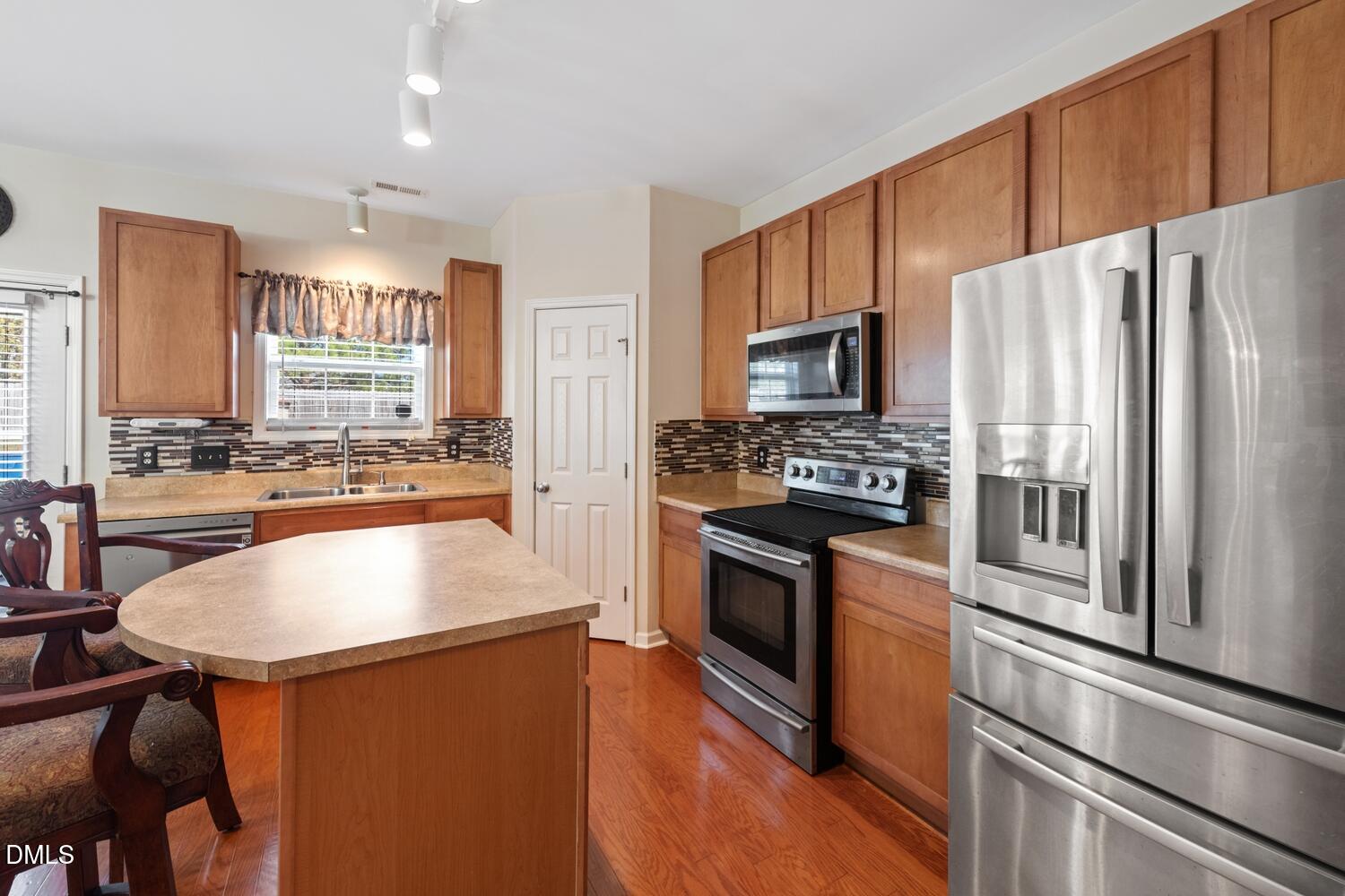 4113 Lady Slipper Lane Durham, NC 27704 - Photo 11 of 28 a kitchen with stainless steel appliances a refrigerator a stove a sink and a refrigerator
