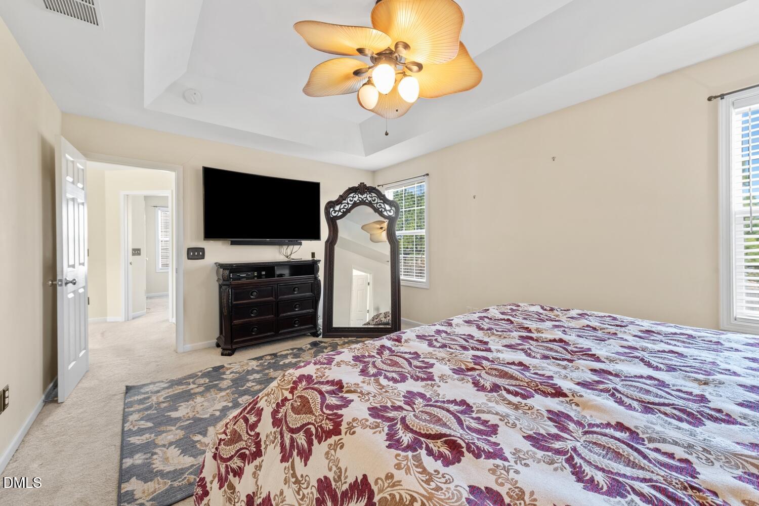 4113 Lady Slipper Lane Durham, NC 27704 - Photo 15 of 28 a bedroom with a bed and a flat screen tv