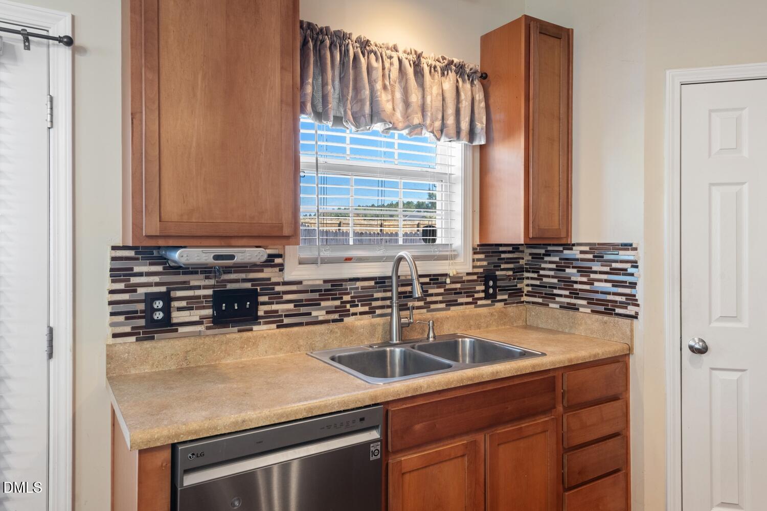 4113 Lady Slipper Lane Durham, NC 27704 - Photo 9 of 28 a kitchen with a sink and cabinets