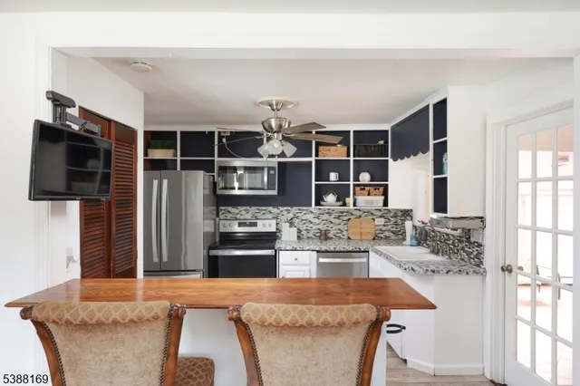 a living room with fireplace furniture and a flat screen tv