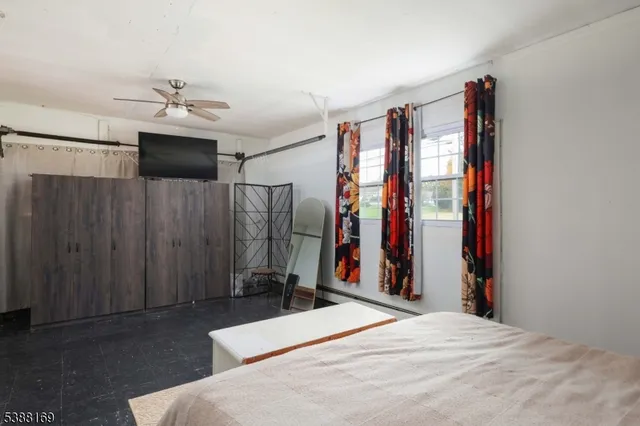 a bedroom with a bed dresser and a window